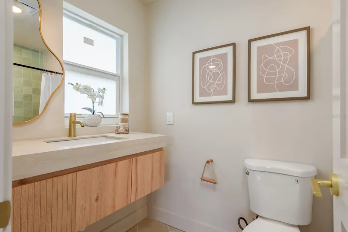 primary suite bathroom double vanity and commode