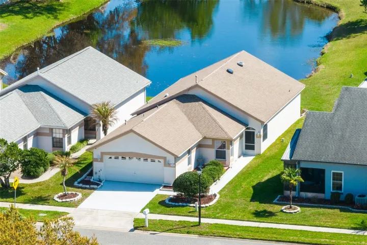 Large windows draw your eye toward the backyard and tranquil waterfront pond setting, creating a relaxing atmosphere throughout the main living spaces.