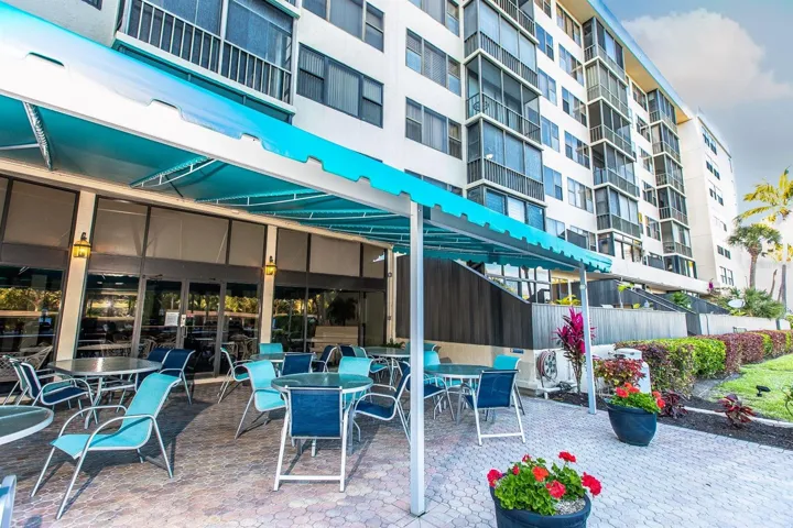OUTDOOR SEATING BY THE CLUBHOUSEE AND BBQ AND POOL