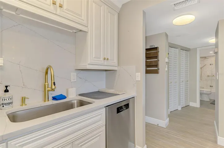 STONE COUNTERS AND BACK SPLASH WITH LUXURY GOLD FINISH FAUCET