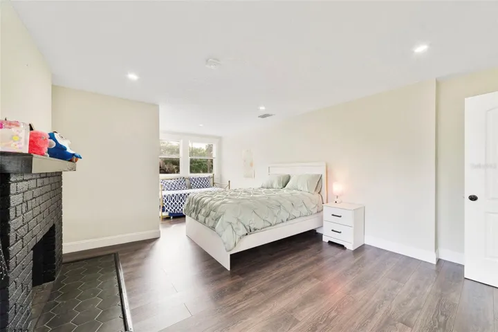 Spacious third bedroom is complete with a fireplace.