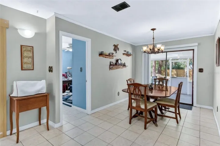 Dining area, with sliding door opening to the screen patio and view of the oversized yard