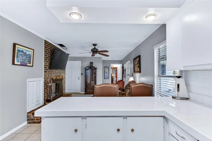 Kitchen has breakfast bar, opens to family room and cozy fireplace