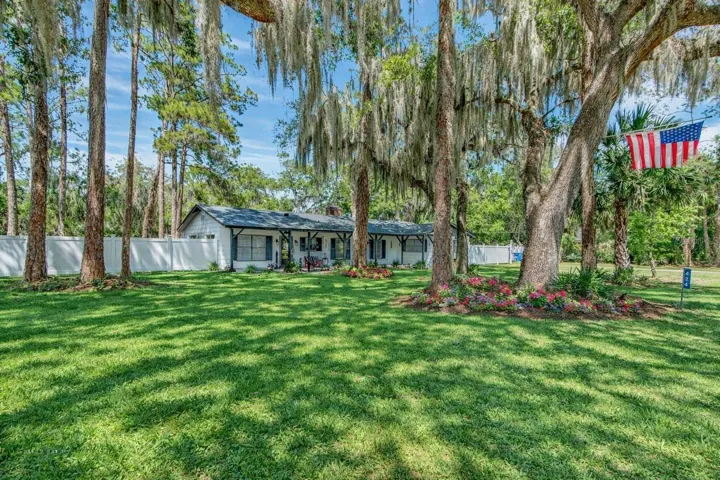 Front lawn with shady trees and wrap around porch