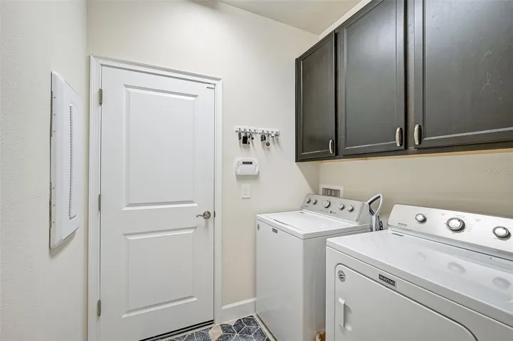 Inside Laundry headed out the door into a spacious 3 bay garage!