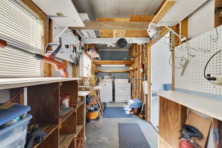 Storage Shed with Washer/Dryer and yard tools.