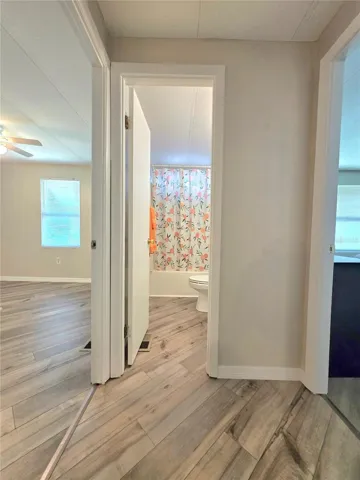 Short hallway off kitchen to main bathroom &amp; bedrooms.