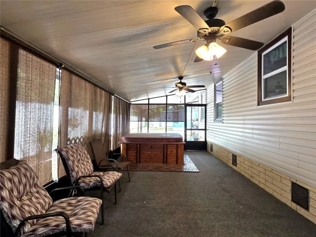 Large screen porch with ceiling fans, roll-down sunshades, hot tub &amp; attached utility/golf cart garage.