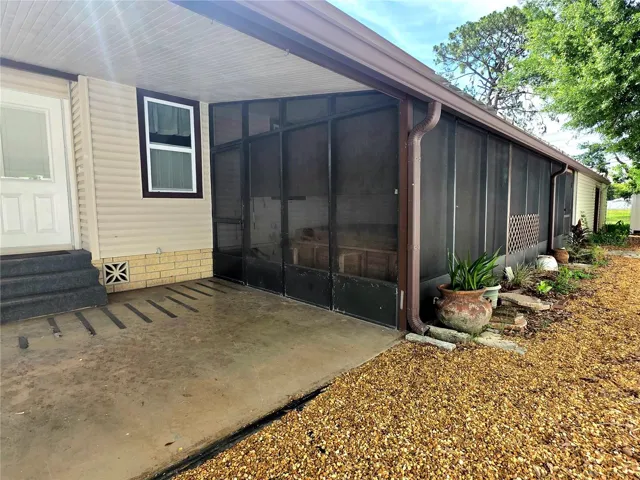 Screen porch with attached utility/golf cart garage.