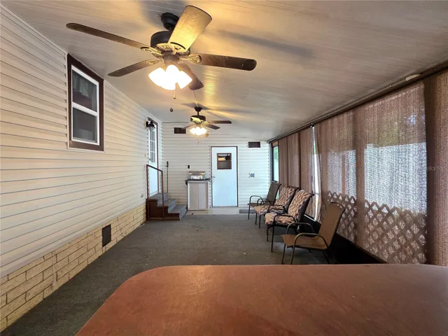 Large screen porch with ceiling fans, roll-down sunshades, hot tub &amp; attached utility/golf cart garage.