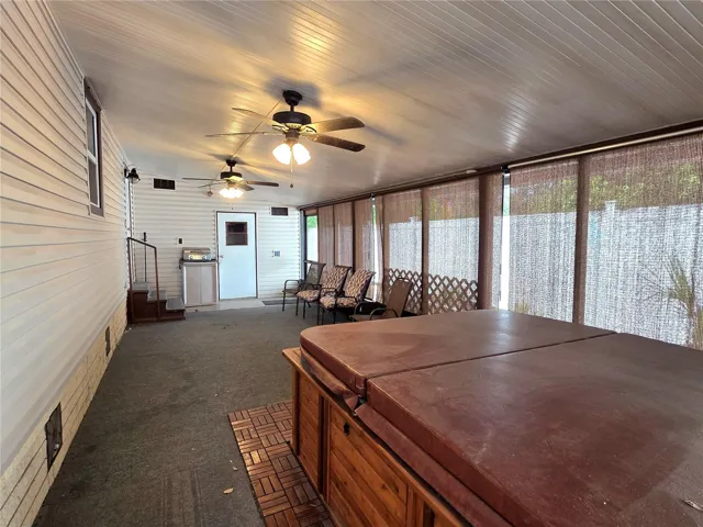 Large screen porch with ceiling fans, roll-down sunshades, hot tub &amp; attached utility/golf cart garage.