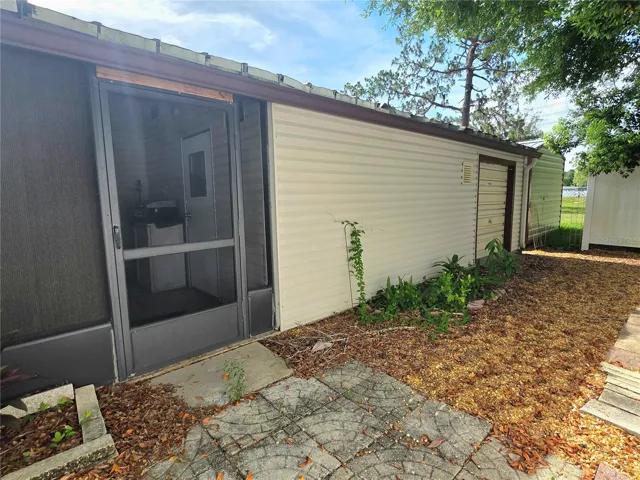 Screen porch with attached utility/golf cart garage.