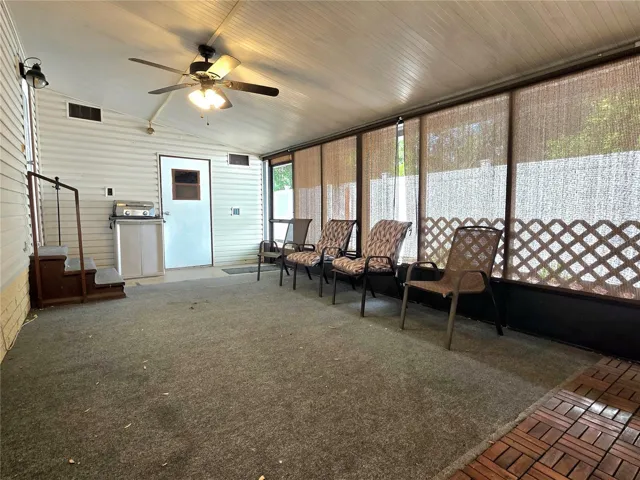 Large screen porch with ceiling fans, roll-down sunshades, hot tub &amp; attached utility/golf cart garage.