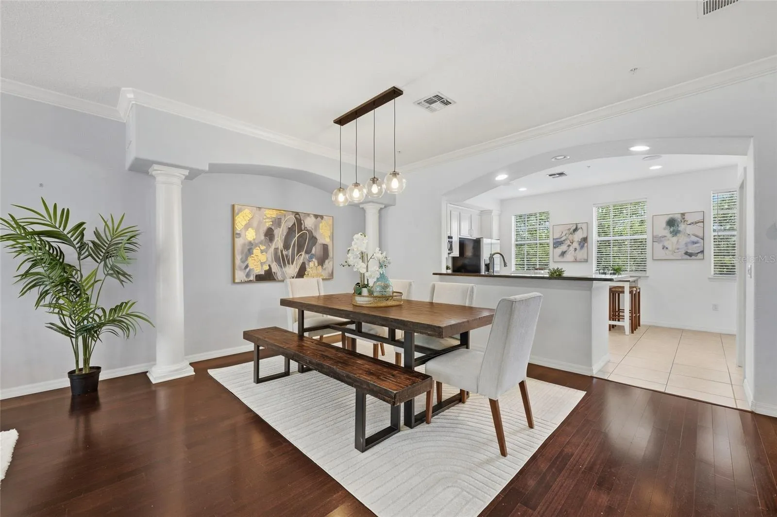 Generously sized dining space framed by architectural columns and open to the living area.
