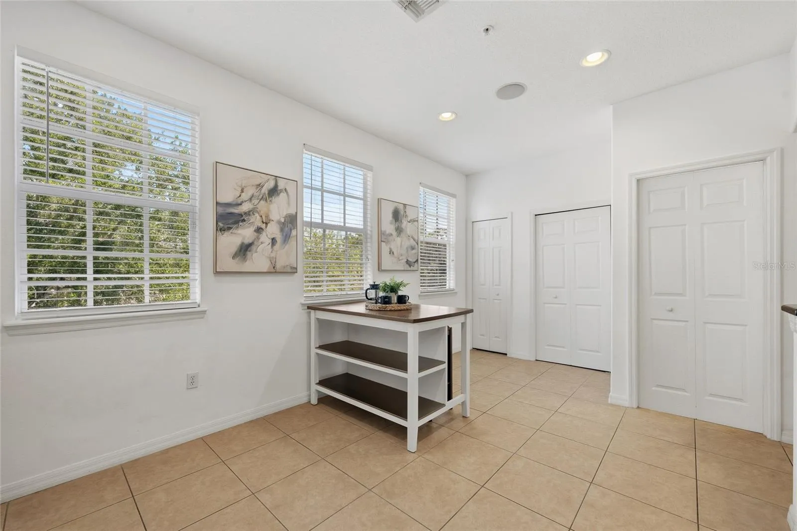 Flexible breakfast area surrounded by windows, with additional storage nearby.