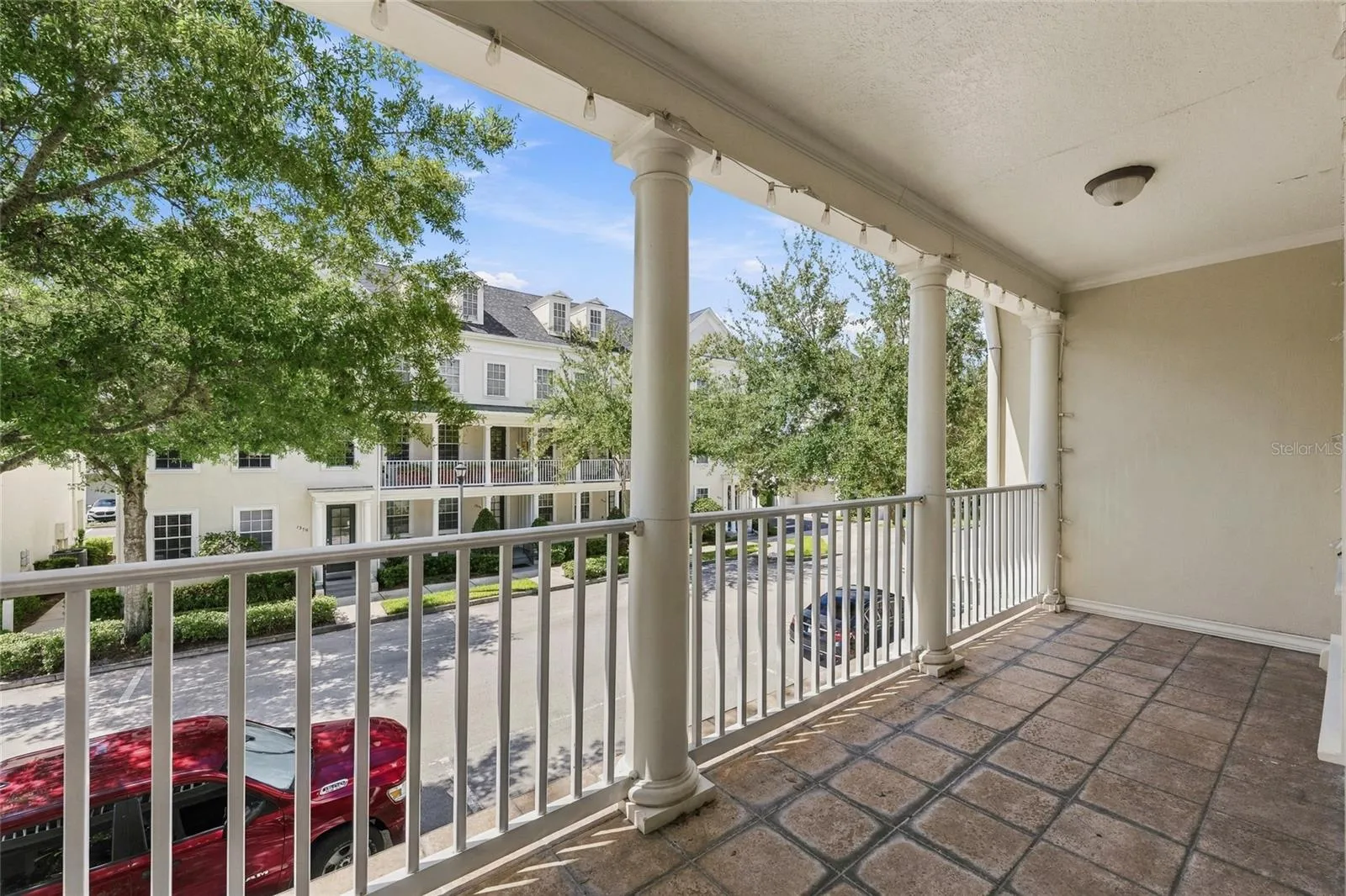 Generously sized covered balcony overlooking the charming Baldwin Park streetscape.