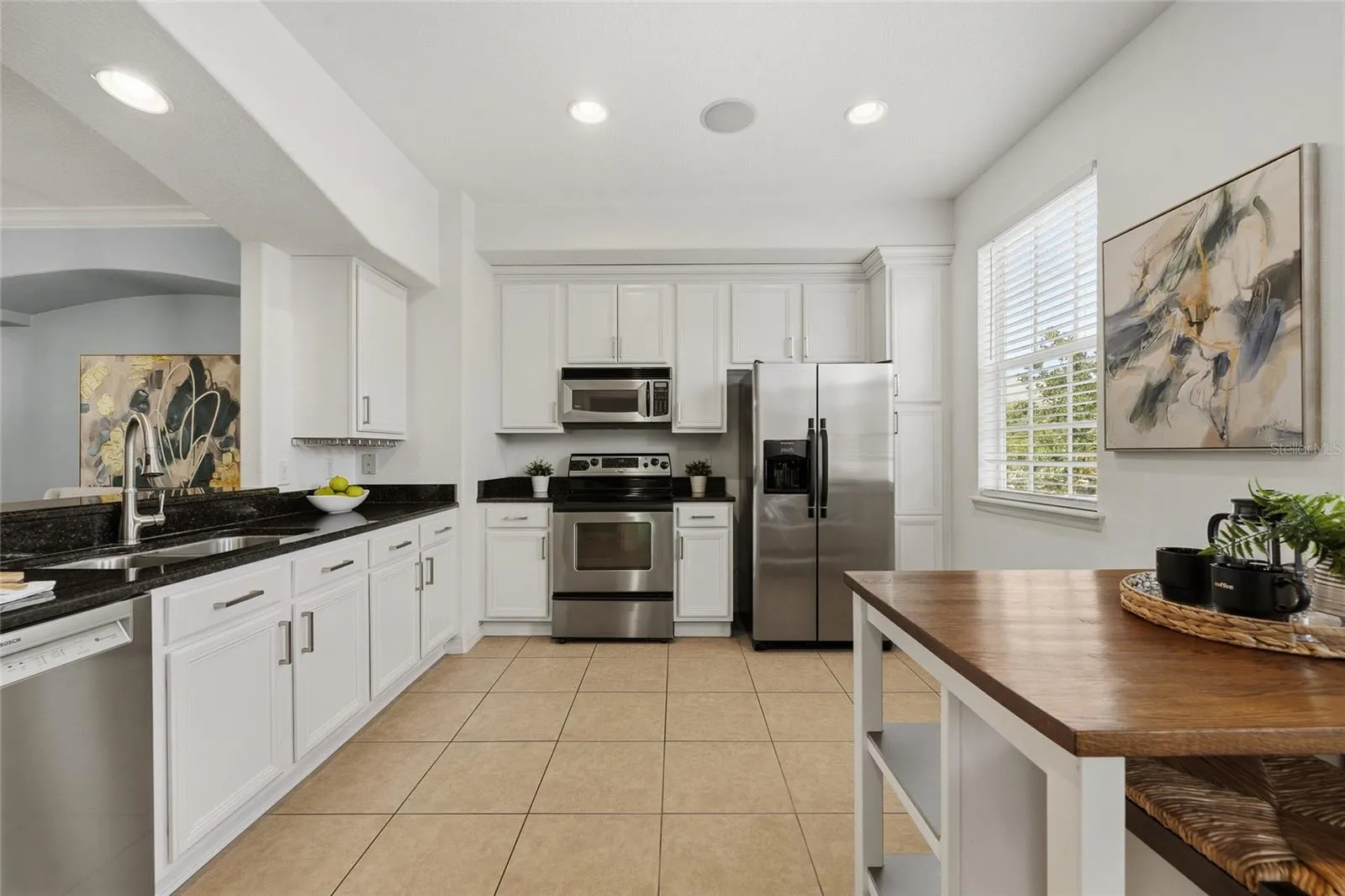 Well-appointed kitchen with extensive cabinetry, granite countertops and stainless steel appliances.