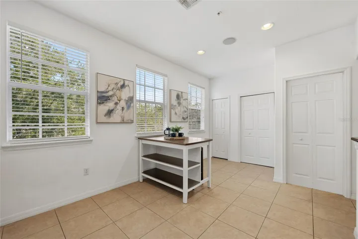 Flexible breakfast area surrounded by windows, with additional storage nearby.