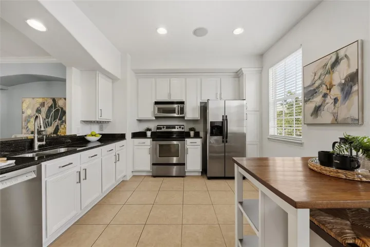 Well-appointed kitchen with extensive cabinetry, granite countertops and stainless steel appliances.