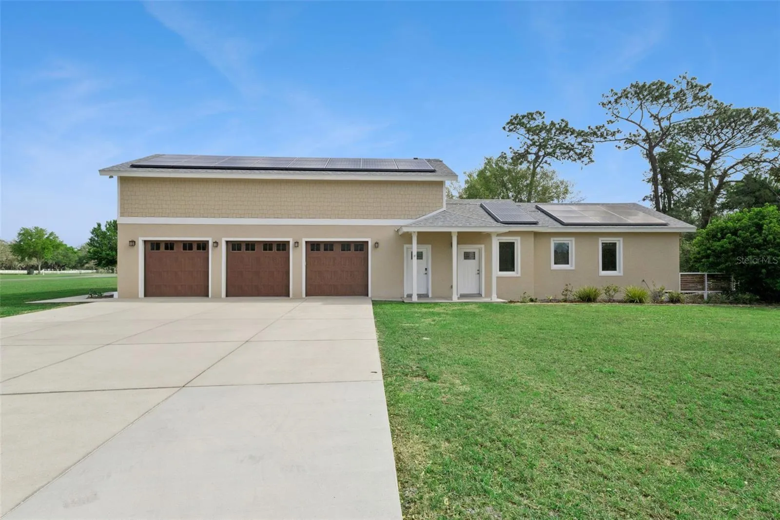 Three car garage with plenty of parking and storage above the entire length of the garage