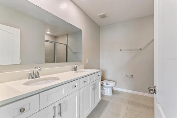 Primary ensuite with double sink vanity.