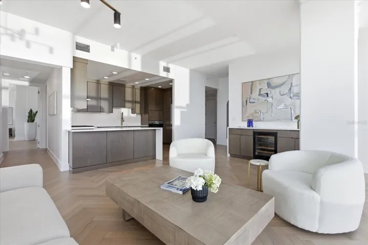 From the southwest corner, the perspective shifts - revealing the depth of the residence as it extends back toward the entry and private wing, with the kitchen set quietly along the way.