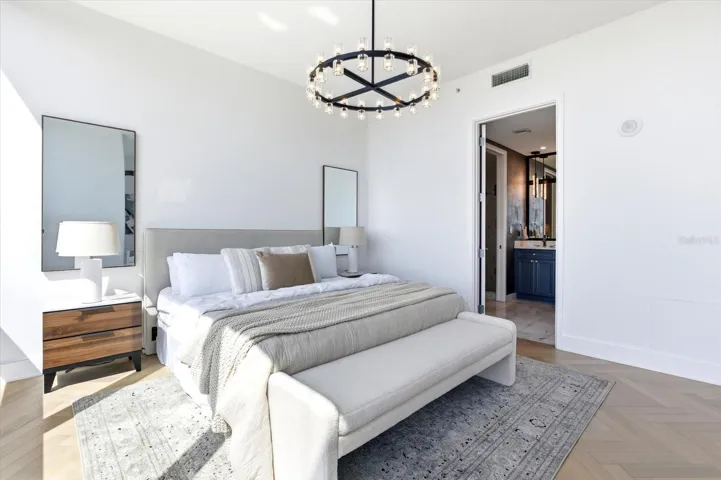 The bedroom transitions into the private bath, continueing the suite's refined, hotel-inspired flow.