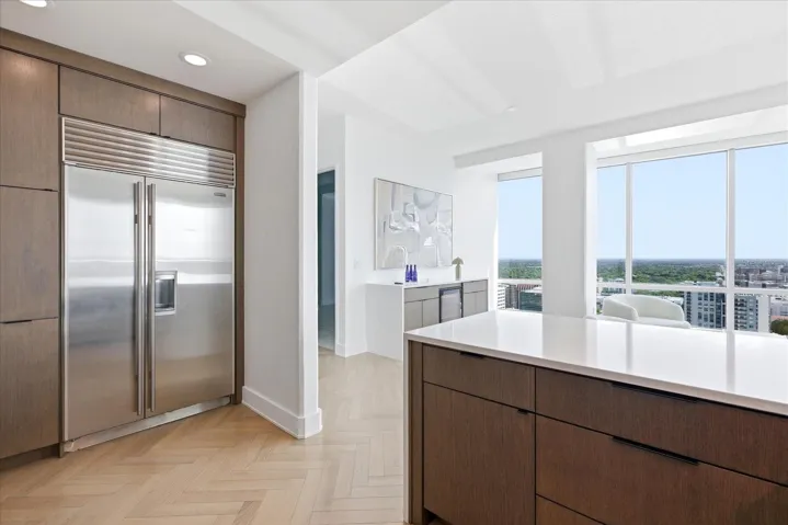 Opposite the Wolf range, a Sub-Zero framed in rift oak - completing a kitchen designed with quiet precision and effortless flow into the home's entertaining spaces.