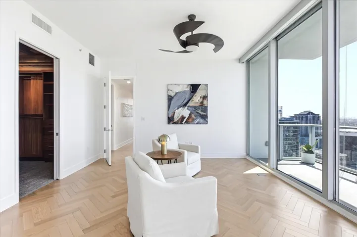 Lounge connects directly to the walk-in closet, with light and views continuing through the suite.