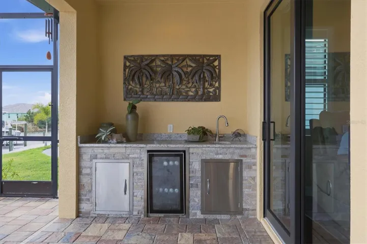 Out door entertaining area with sink and beverage fridge