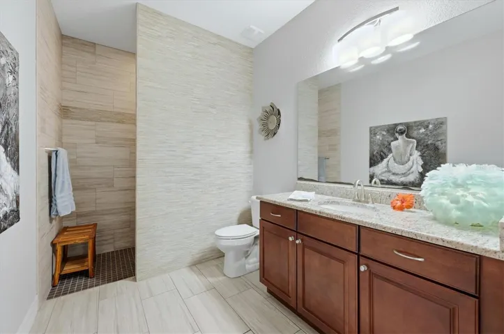 Guest Bath has walk in shower and door to pool access