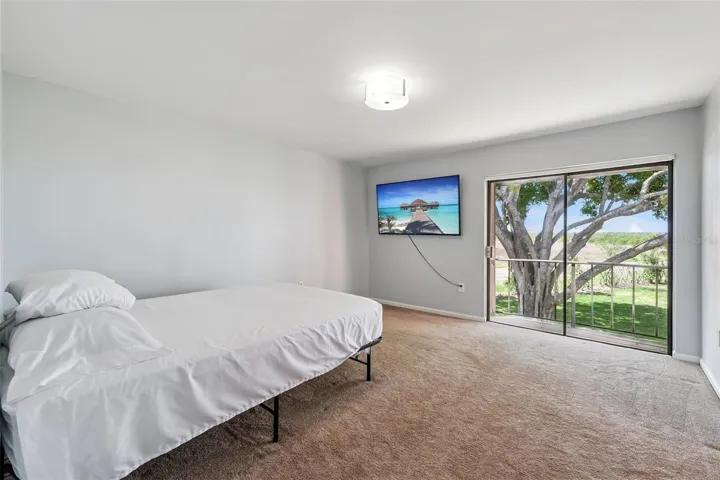 Primary bedroom with view of grounds