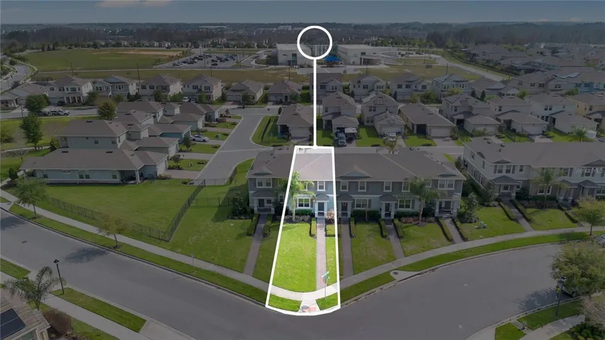 Aerial view showcasing the expanded lot size compared to neighboring properties