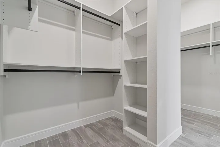 Primary suite closet is a double sided, professionally updated california closet beauty !
