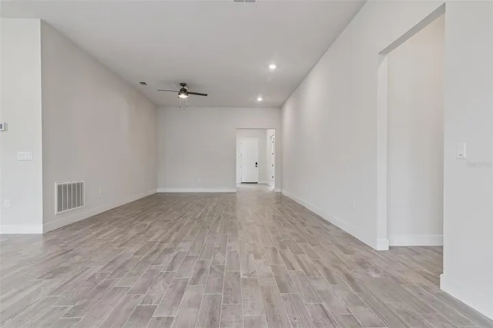 Standing in great room, looking towards the front door you can imagine your large dining room set will have plenty of space to enjoy those family dinners.