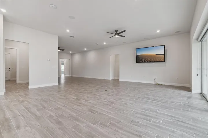 Main great room view from the kitchen with surround sound speakers with subwoofer.