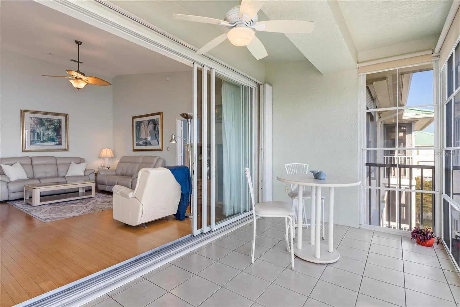 Three pocketed sliders transition from lanai to living room.