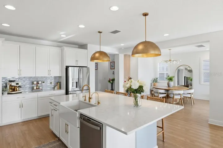 Designer kitchen with gas cooktop and upscale lighting