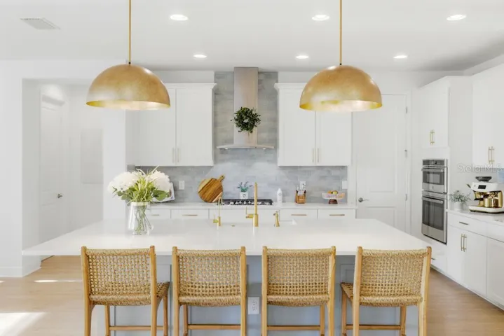 Oversized Cambria quartz Island with a custom built walk-in pantry