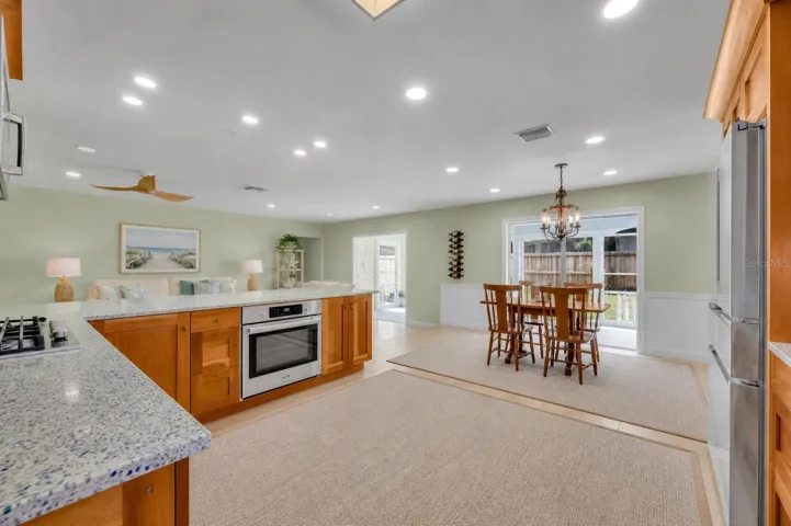 Updated kitchen opens to family room and Florida room