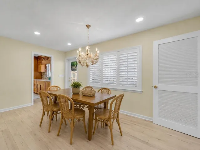 Formal dining room connects to the kitchen and offers pocket door for privacy - Virtually Staged