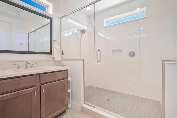 The Primary Bathroom is designed to impress, featuring dual sinks, an OVERSIZED STEP-IN SHOWER with built-in bench, and a private water closet—your own personal sanctuary.