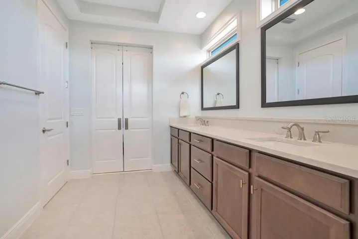 The Primary Bathroom is designed to impress, featuring dual sinks, an OVERSIZED STEP-IN SHOWER with built-in bench, and a private water closet—your own personal sanctuary.