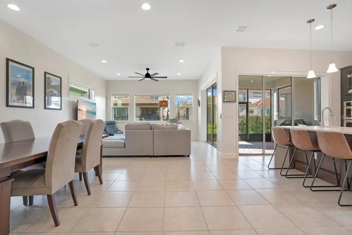 Step inside to discover a bright OPEN-CONCEPT FLOOR PLAN where the Living Room, Dining area, and Kitchen flow seamlessly together, all enhanced by sleek tile flooring throughout the main level.