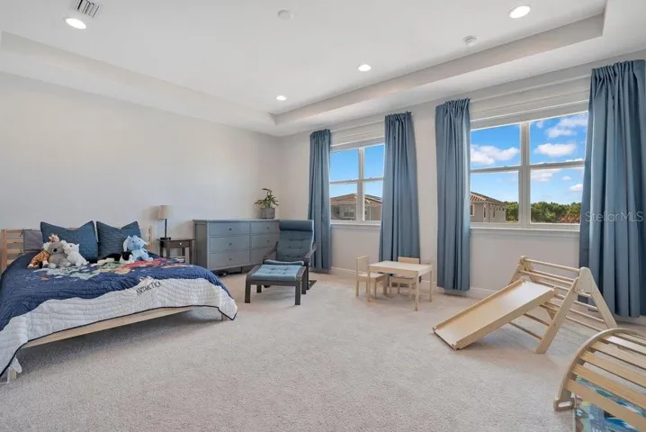 Two additional bedrooms are located upstairs, including an EXTENDED BEDROOM with tray ceilings and dual closets, offering extra space and flexibility.