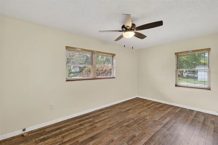 Primary Bedroom with ceiling fan and ensuite half-bath.