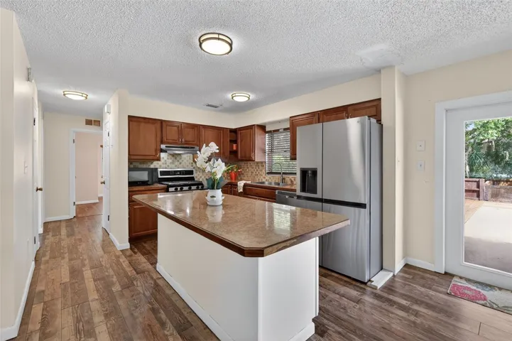 Kitchen with view to hall and three bedrooms.