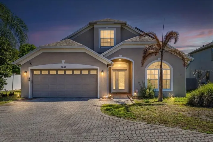 Twilight. Beautiful 5 bedroom, 3 bathroom pool home with approximately 2,530 square feet of living space situated on an oversized 0.30 acre flag lot, a rare opportunity to own a pool home with this much outdoor space in the desirable Vista Lakes area.