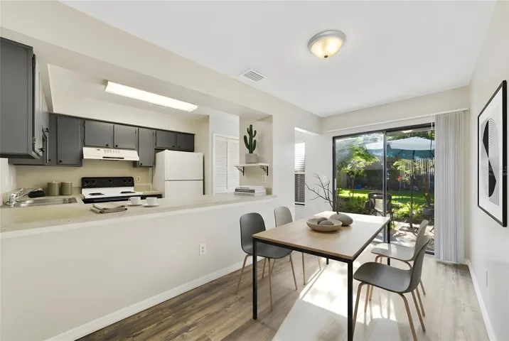 A cozy Dining area provides room for a small table and chairs and features sliding glass doors that open to the PRIVATE PATIO. Virtually Staged