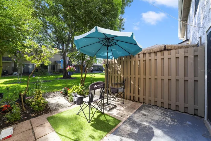 Step outside to the rear patio, complete with PRIVACY FENCING on both sides.